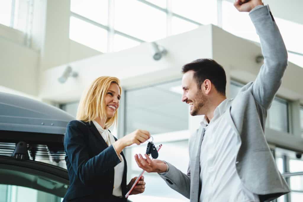 portrait of happy customer buying car