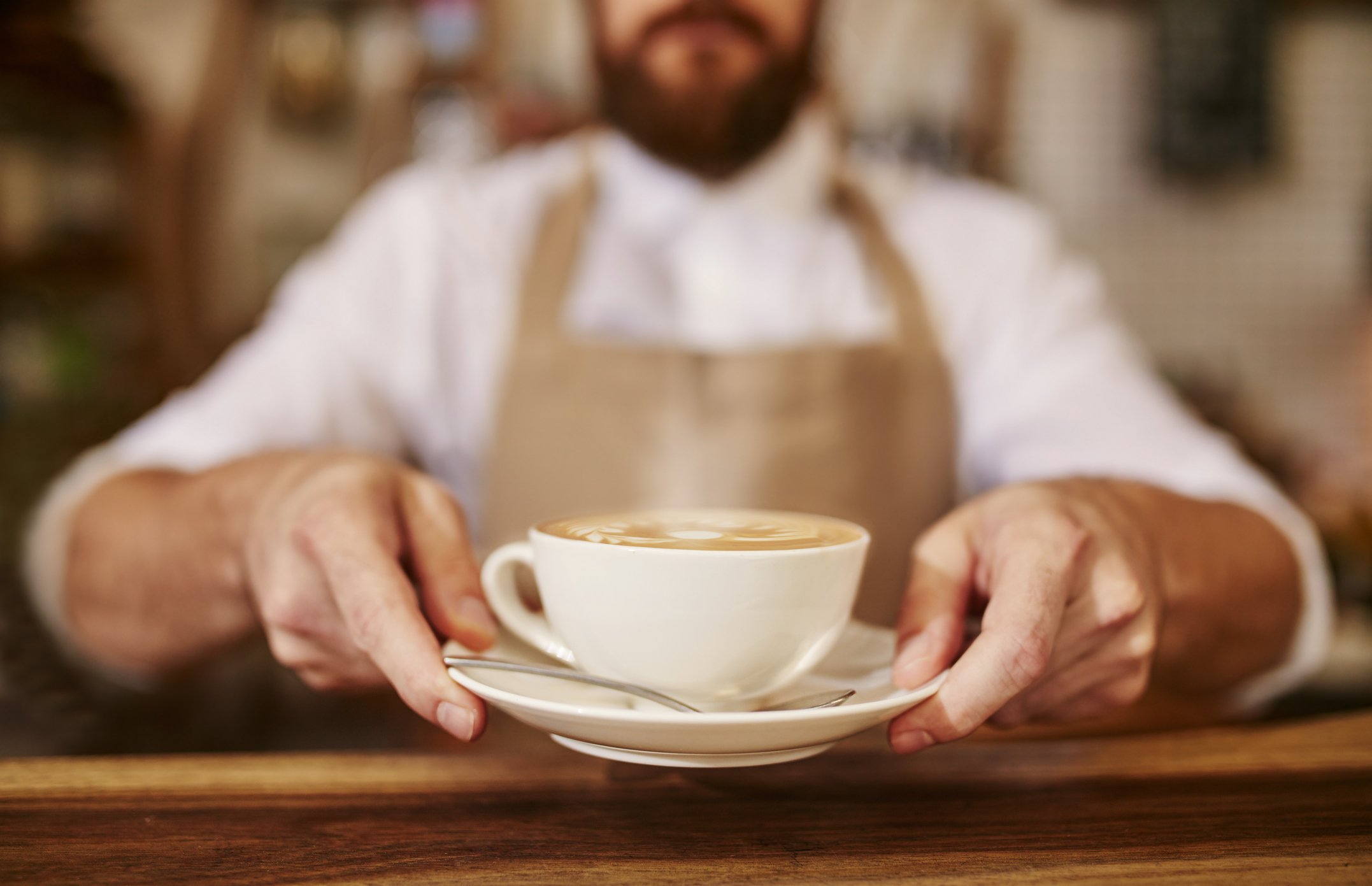 Barista serving coffee