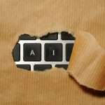 A piece of cardboard with a keyboard appearing through it