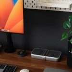 a desk with a laptop, keyboard, mouse and a monitor